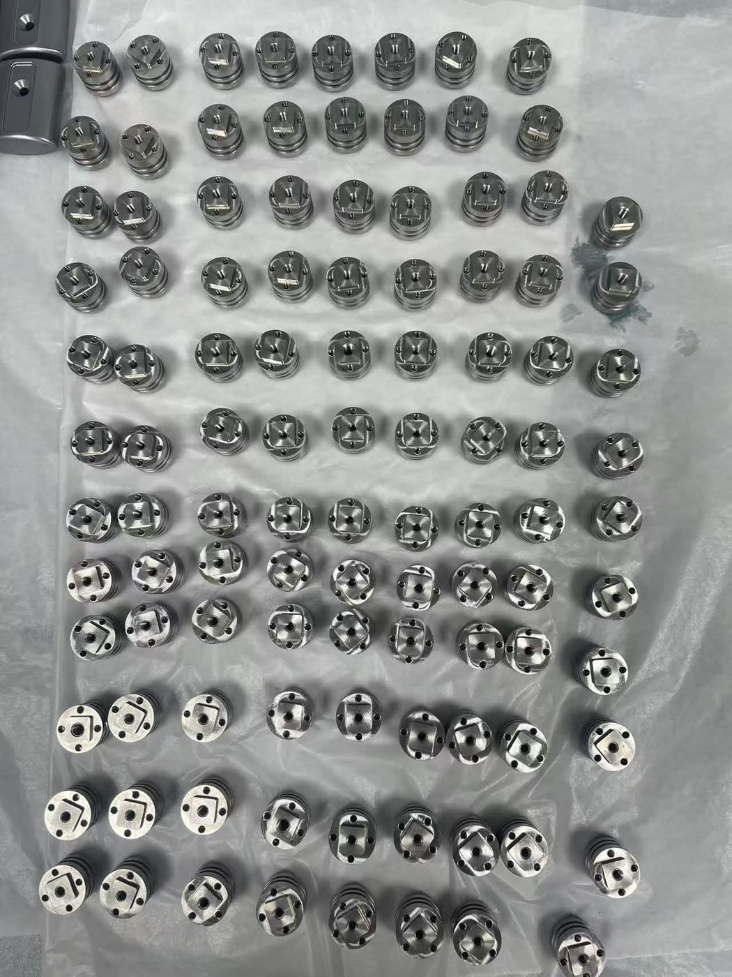 Tray of 100+ precision-machined stainless valve core components